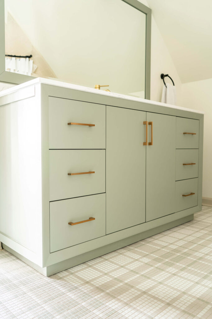 Luxury home design in a guest bathroom with a painted gray vanity.