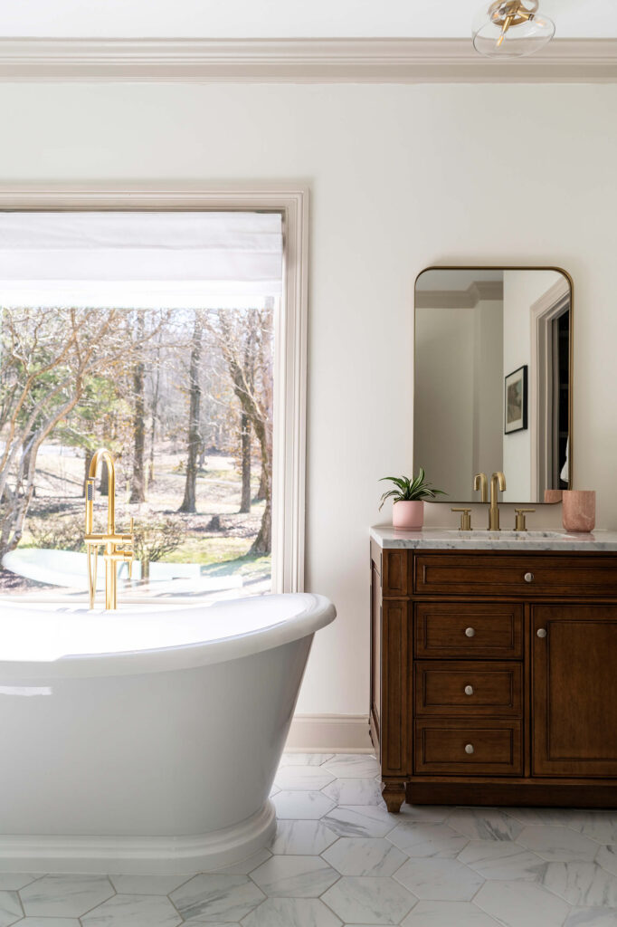 Luxury bathroom design with a freestanding bathtub and dark wood vanity, by Holly Thompson Design.