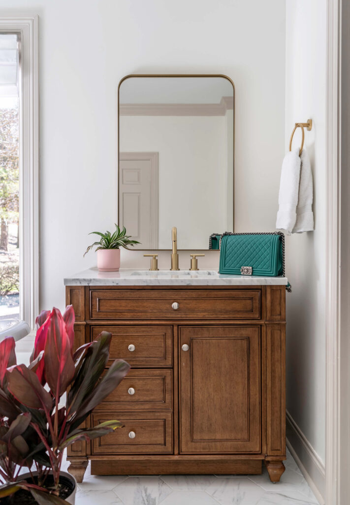 A dark wood vanity with a marble countertop.